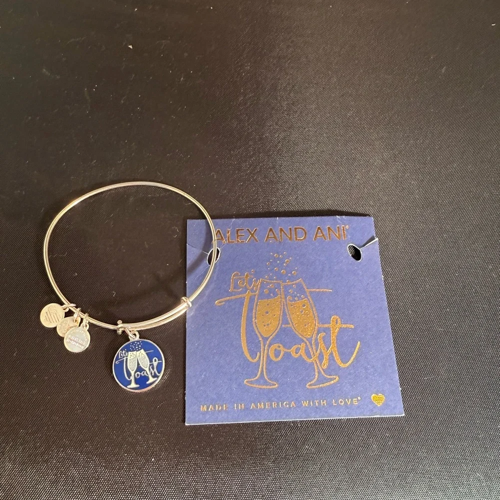 Alex and Ani Silver Bangle with Blue “Let’s Toast” Charm - Picture 2 of 2